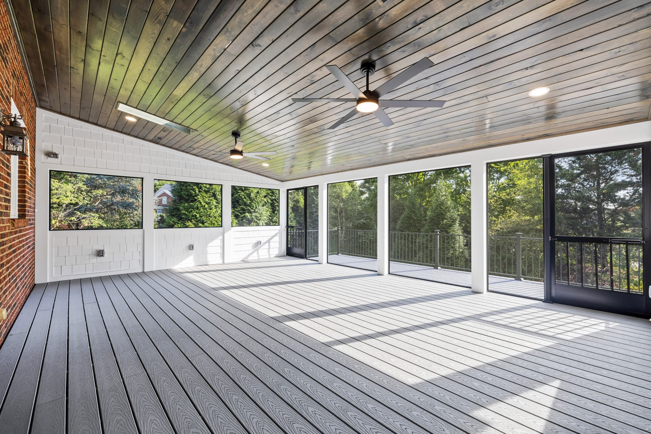 Custom multi-level deck with composite decking and black powder-coated stainless steel baluster railings built by Volunteer Decks in Knoxville, TN