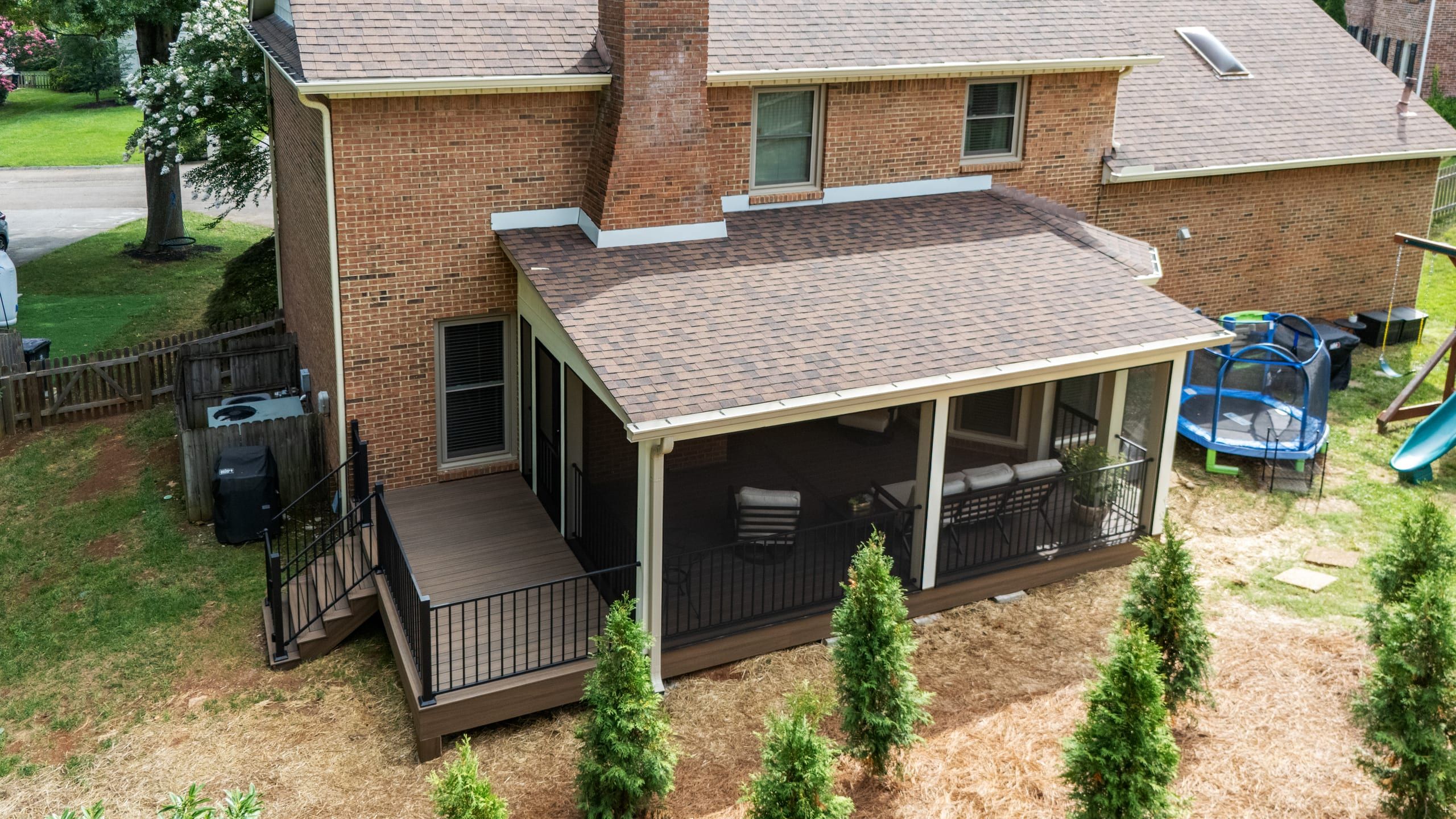 Aerial view over the Ashgrove porch roof showing the addition, the open deck, and steps to the yard