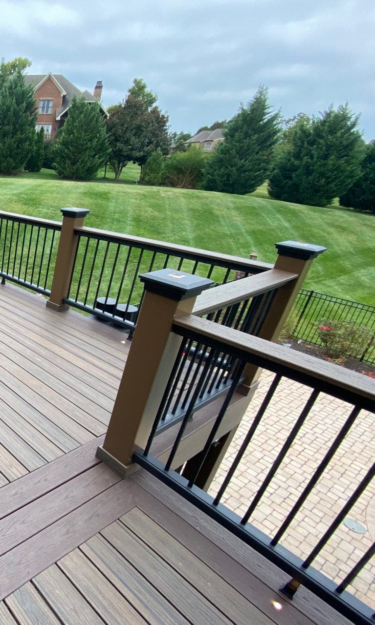 Vinyl-wrapped pressure treated railing with Trex composite top rail and black aluminum balusters